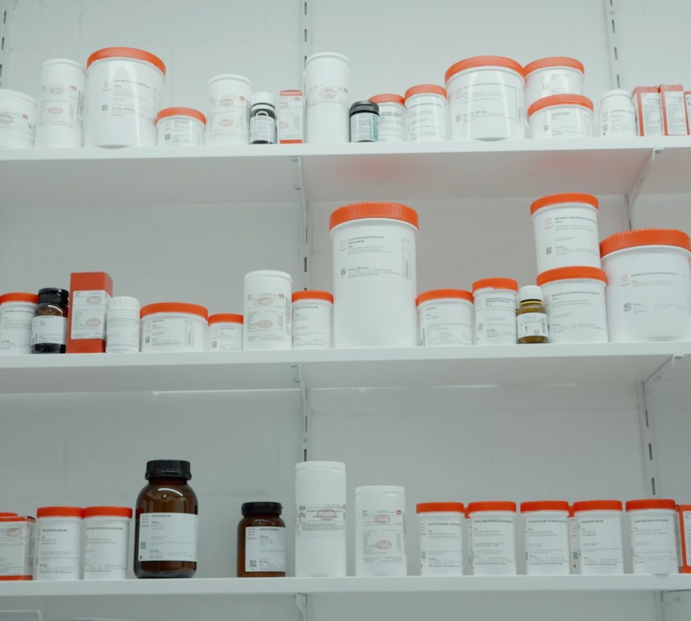 Pharmacy shelves stocked with medicine bottles